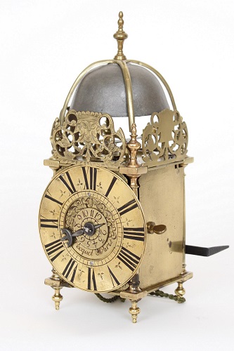 A small French engraved brass lantern wall clock with alarm, Pequet A Paris, circa 1720.